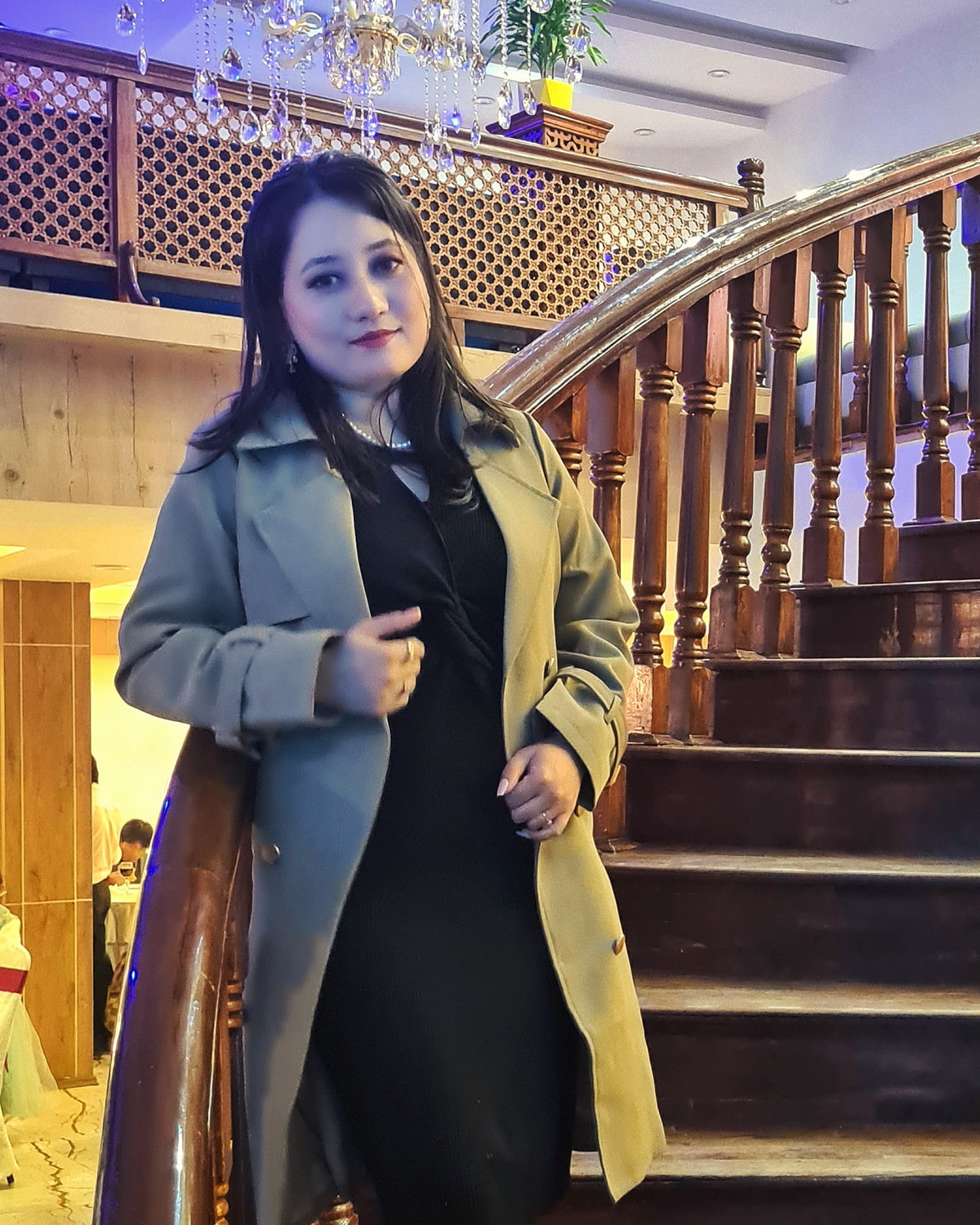Rachana Shrestha on a wooden staircase